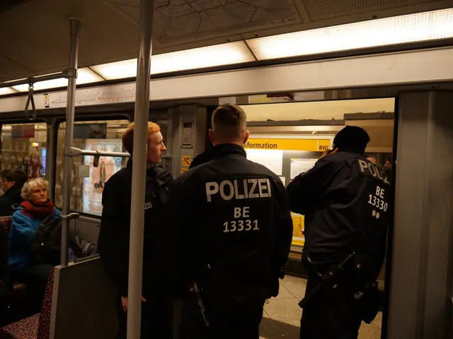 The image shows a group of police officers standing next to each other on a subway train. There are...