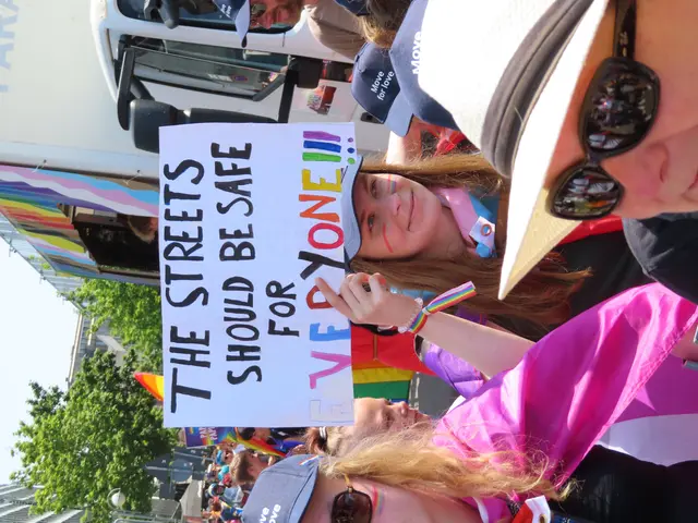 The image shows a group of people standing in front of a truck, holding a sign that reads "The...