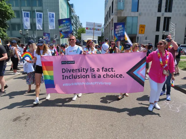 The image shows a group of people walking down a street, holding a banner that reads "Diversity is...