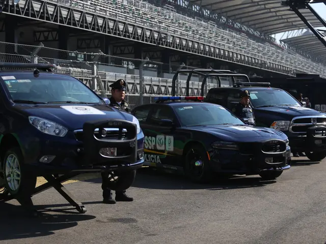 The image shows a group of police cars parked in front of a race track, with people wearing...
