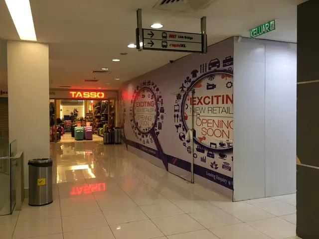 The image shows the entrance to a shopping mall with a sign that reads "Exciting New Retail Opening...