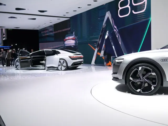 The image shows an Audi e-tron concept car on display at the Frankfurt Motor Show, surrounded by a...