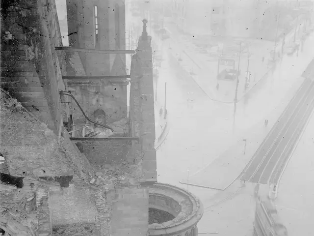The image shows a black and white photo of a city street with a building in the foreground. On the...